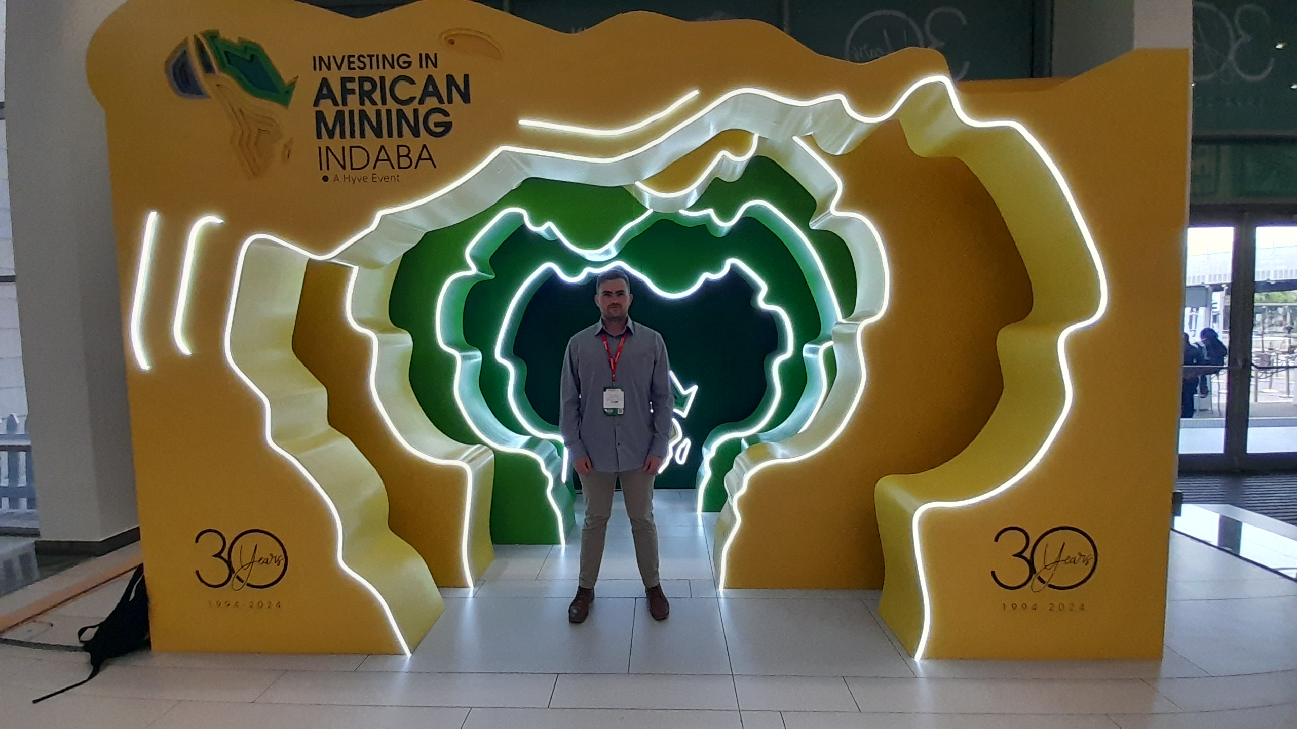 Delegate at the Mining Indaba 2024 entrance display in Cape Town
